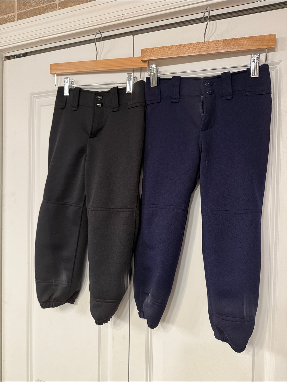 Pair of Girls Mizuno Softball Pants. One Navy, One Black.